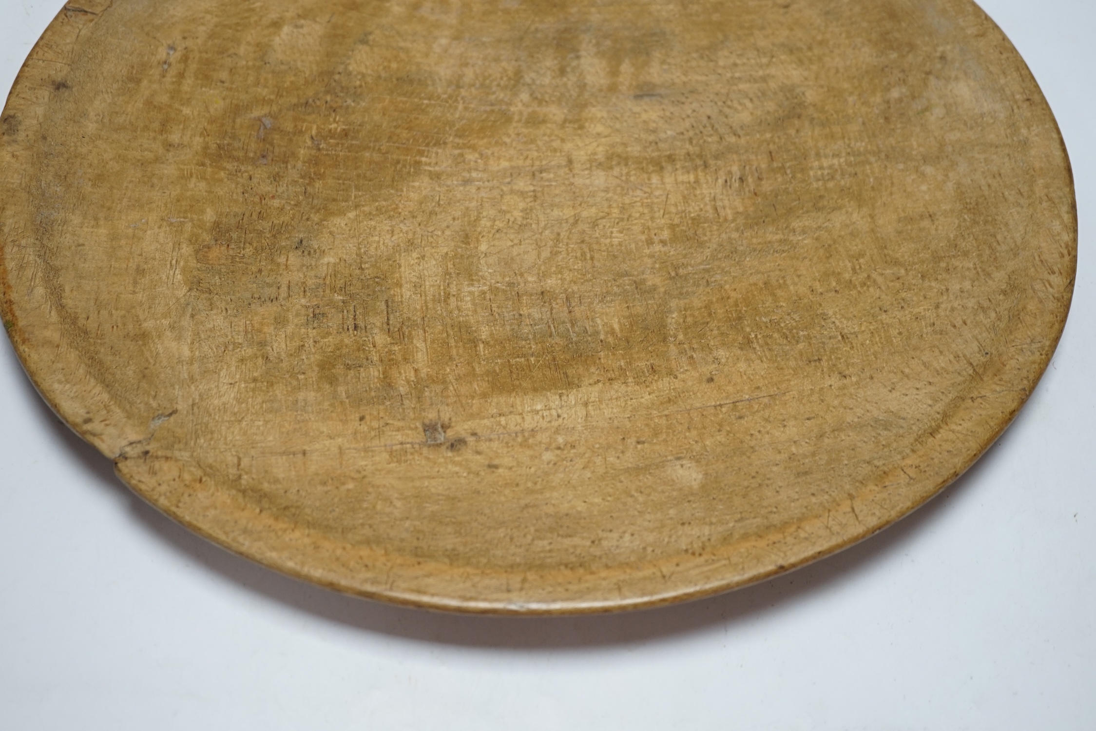 A large turned beech bowl of shallow form, 45cm in diameter